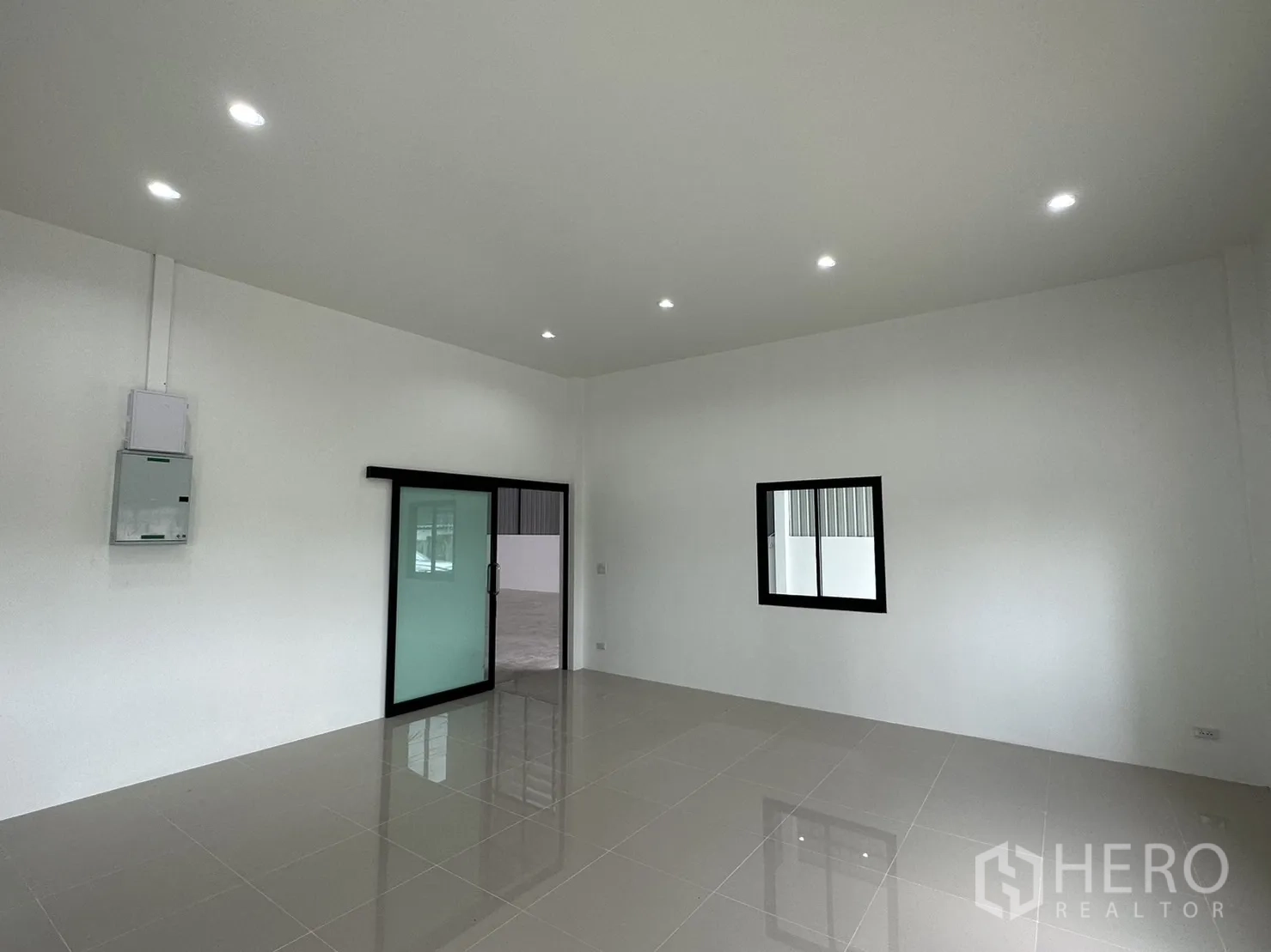 Warehouse for rent or sale - Office room with sliding glass door and clean white walls.