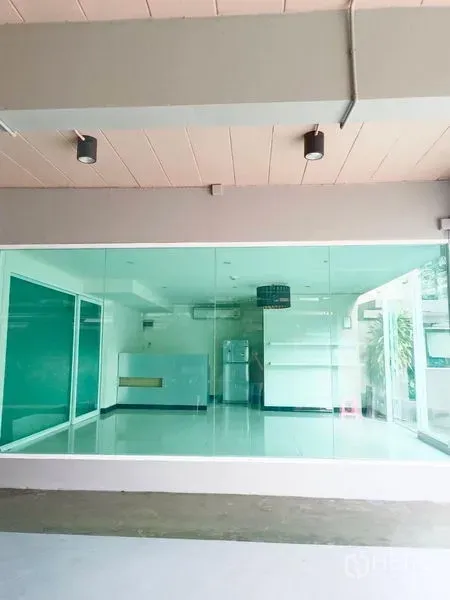 Retail Space for rent - Wide storefront with floor-to-ceiling glazing beneath a covered walkway.