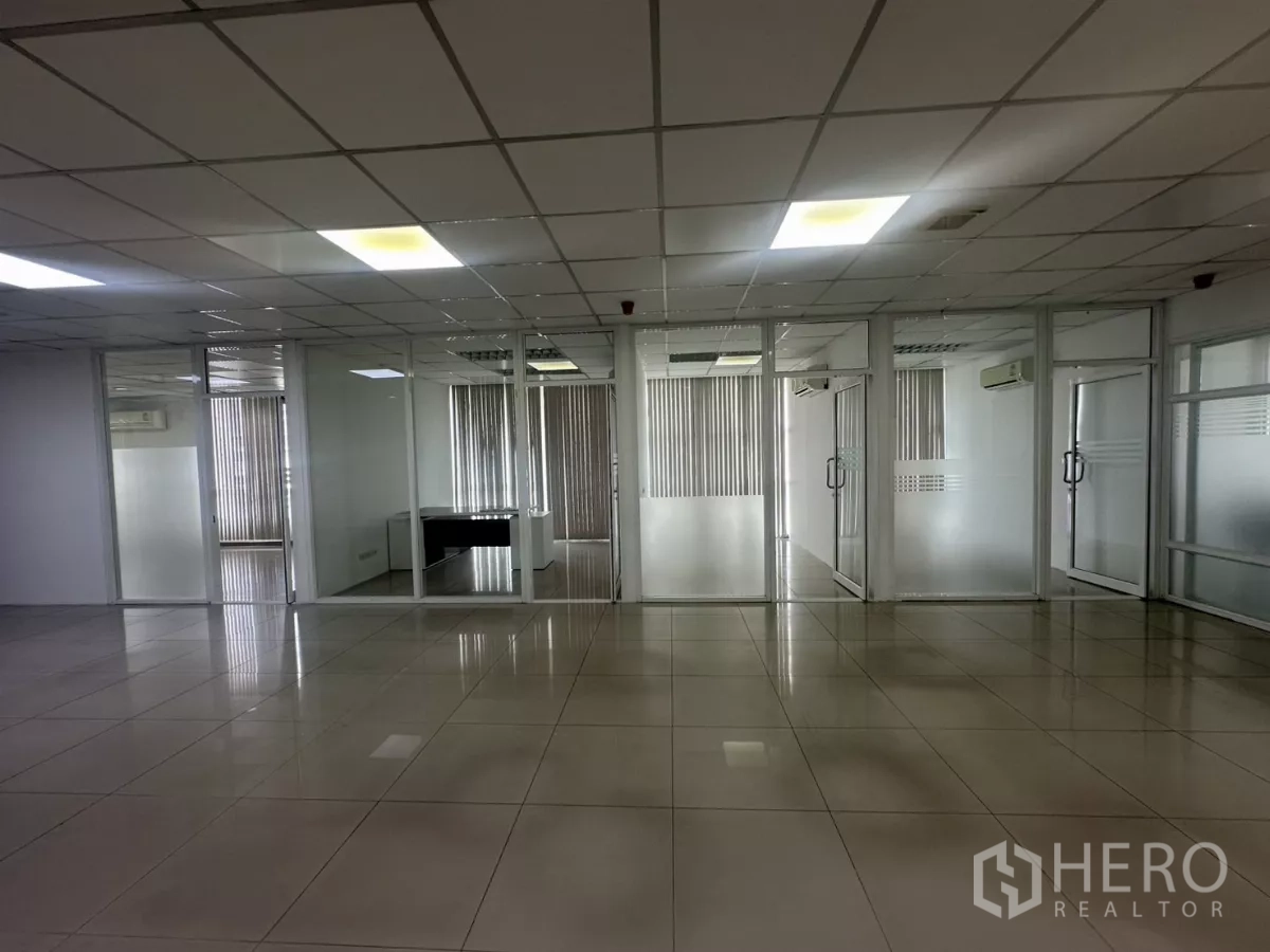 Office Space for rent in Huai Khwang, Bangkok - Row of glass-walled private offices with frosted panels and vertical blinds.