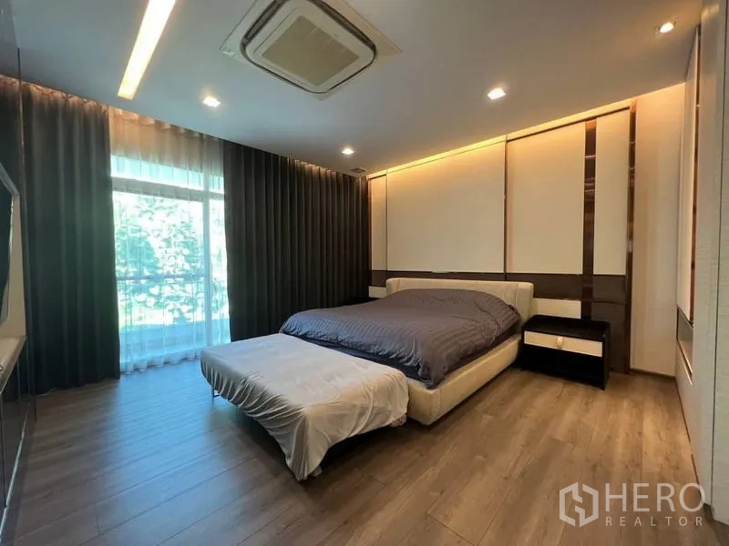 Detached House for rent or sale in Bang Phli, Samut Prakan - Spacious master bedroom with large window, dark drapes and ceiling cassette air-con.