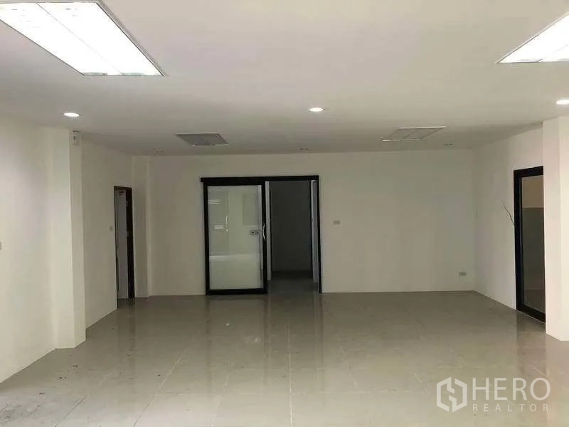 Factory for rent or sale in Bang Phli, Samut Prakan - Expansive office workspace with sliding glass partition and ceiling lights.