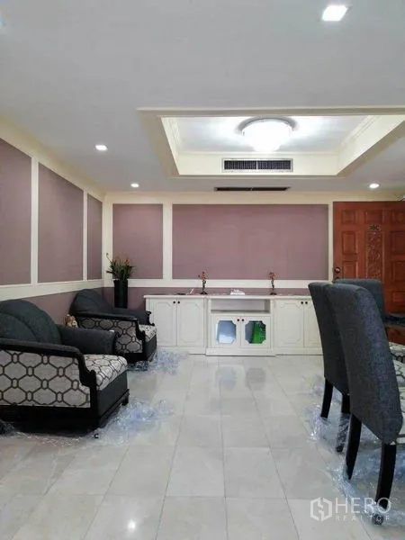 Condominium for rent in Watthana, Bangkok - Living area with sofa set, TV console and balcony access.