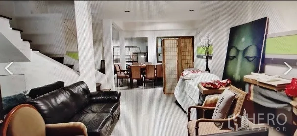 Home Office for rent in Khlong Toei, Bangkok - Long open-plan lounge and dining space with artwork, stairs and a folding screen divider.