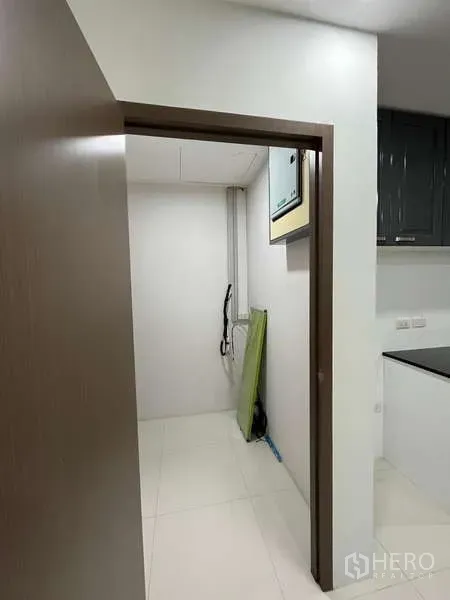 Office Space for rent in Prawet, Bangkok - Compact utility room off the pantry with white tile flooring and equipment.