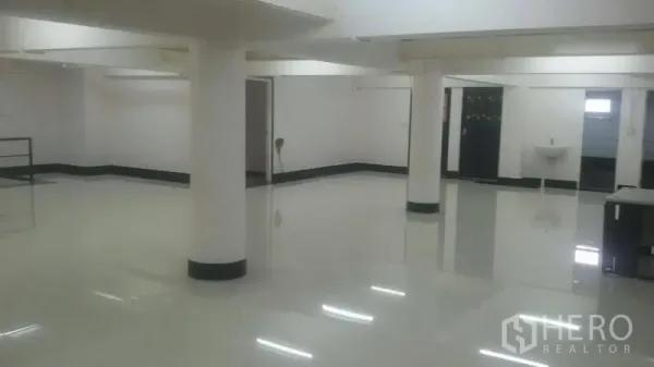 Office Space for rent in Sathon, Bangkok - Spacious office interior showing pillars, a doorway, and a small wash area on a polished floor.