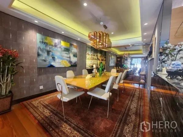 Condominium for sale in Yan Nawa, Bangkok - Elegant dining room with long table, modern chandeliers and wall art.