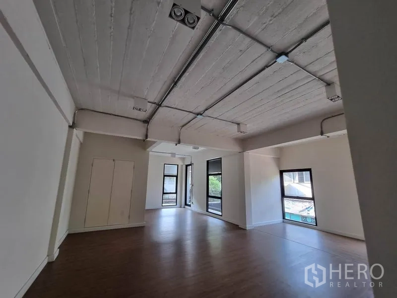 办公空间 出租在Phaya Thai, Bangkok - 开放工作区，涂白外露天花与电线管道，自然采光好