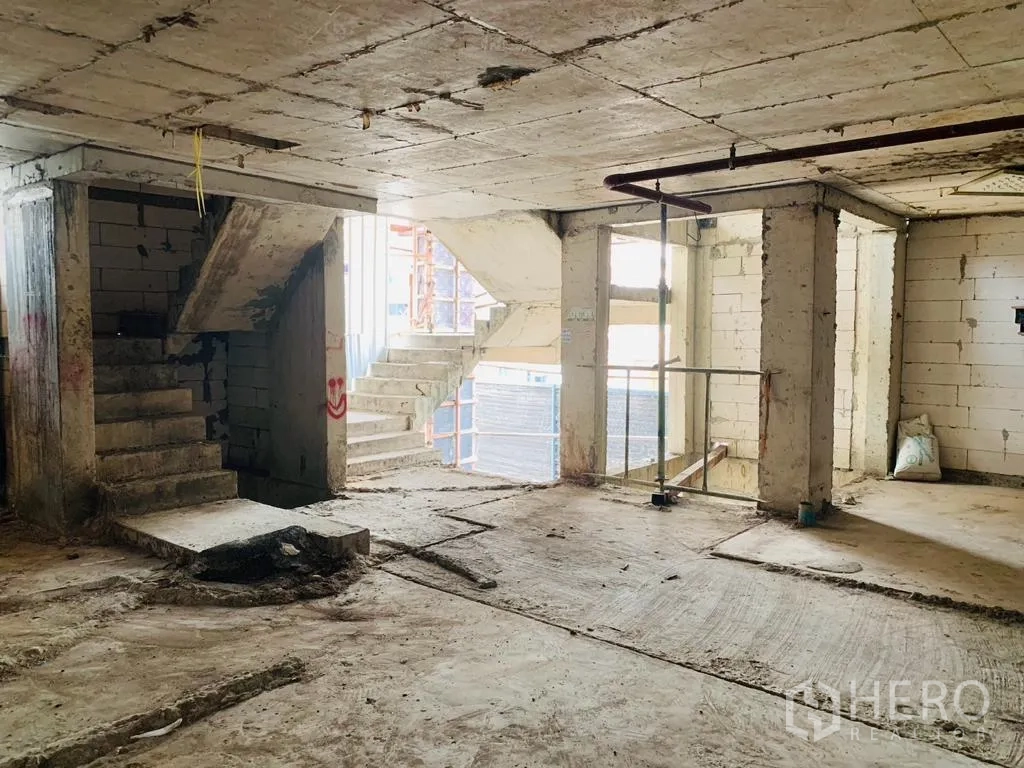 Home Office for rent - Unfinished open-plan level featuring concrete stairs and daylight from large openings.