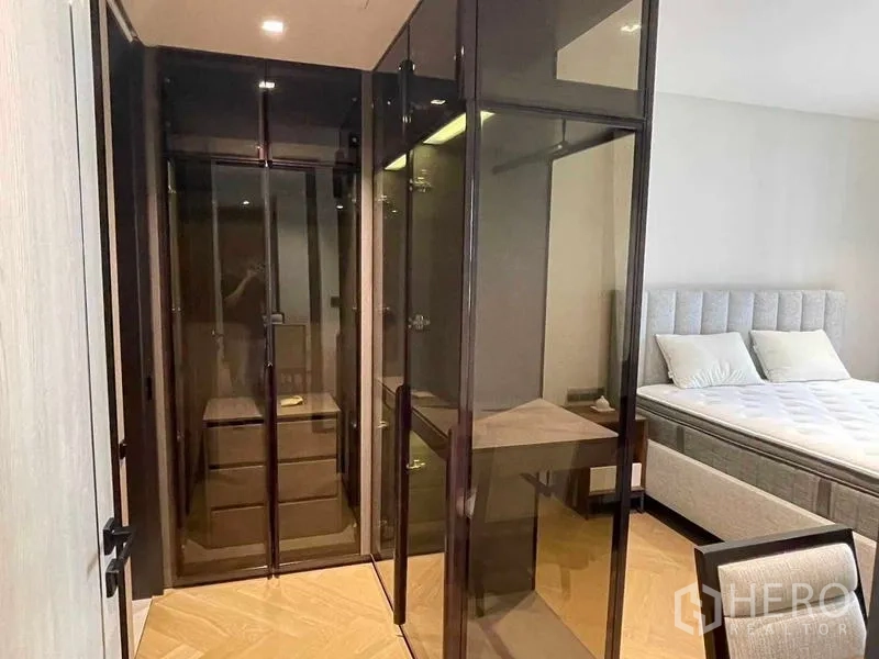 Condominium for rent - Walk-in closet with glass wardrobes and built-in drawers beside the bedroom.