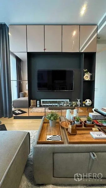 Condominium for sale - Built‑in TV feature wall with glossy cabinets and decor items.