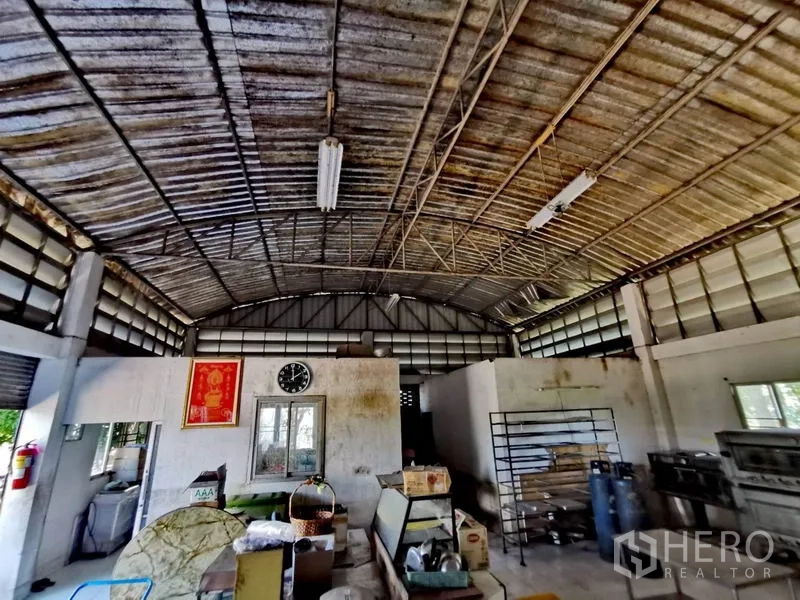 货栈 出售在Pathum Thani - 仓库内部，拱形钢结构屋顶与通风窗，开阔作业区。