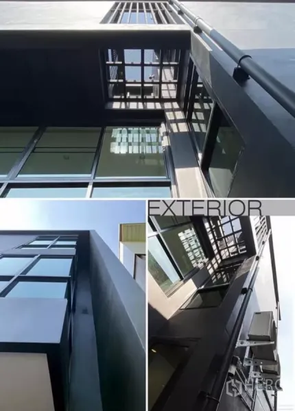Detached House for rent in Huai Khwang, Bangkok - Close-up architectural views of sleek black facade, floor‑to‑ceiling glazing and metal sunshades.