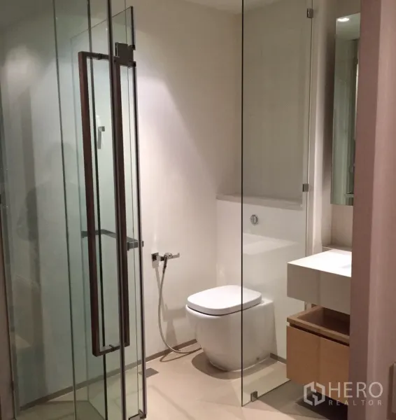 คอนโด ให้เช่าหรือขายในKhlong San, Bangkok - ห้องน้ำสมัยใหม่พร้อมตู้ชาวเวอร์กระจก อ่างล้างหน้า และโถสุขภัณฑ์