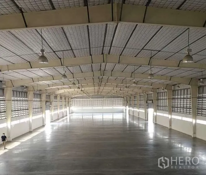 Factory for rent in Bang Bo, Samut Prakan - Expansive factory floor with high arched roof, ventilation louvers and polished concrete suitable for heavy-duty operations.