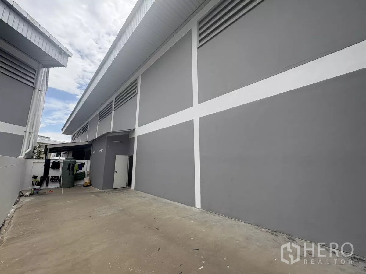 工厂 出租在Phra Samut Chedi, Samut Prakan - 工厂侧立面，设通风百叶与带侧门的后勤庭院。