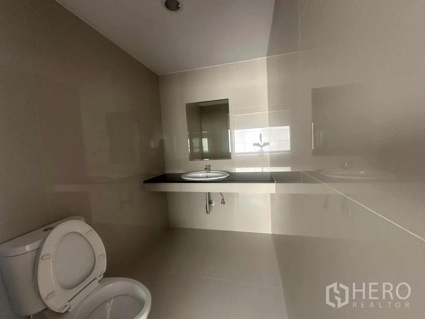 办公室 for rent in Watthana, Bangkok - 瓷砖卫生间，配坐便器、镜子与台面式洗手盆。