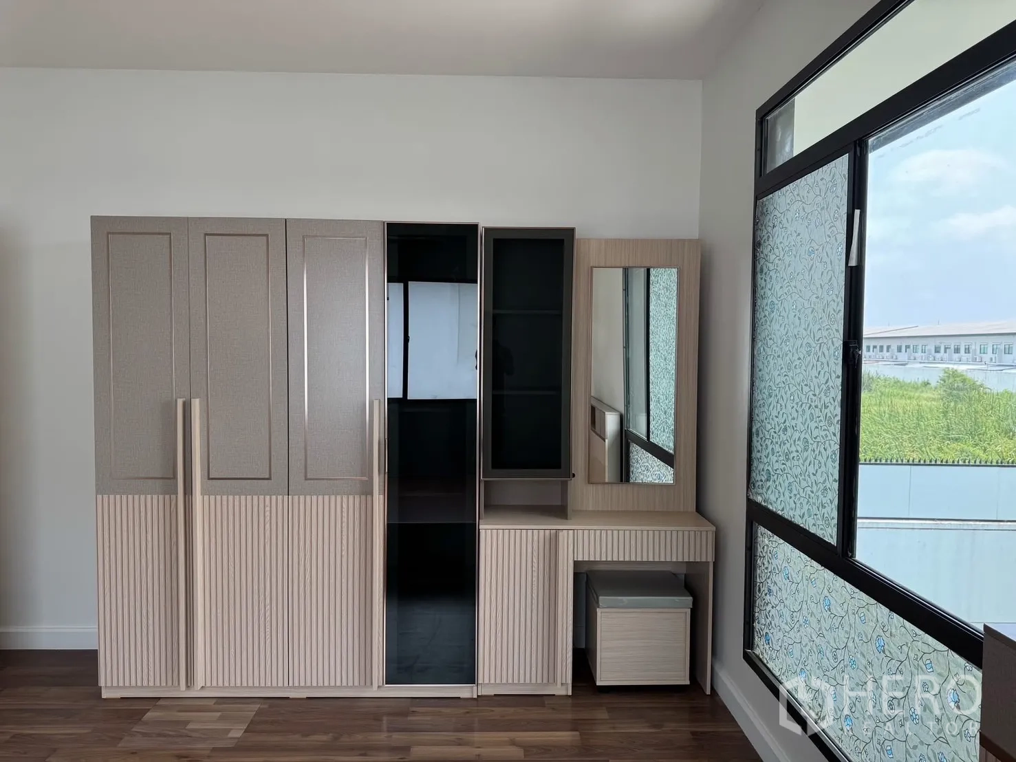 Detached House for rent in Prawet, Bangkok - Fitted wardrobe and dressing table beside a large window with patterned film.