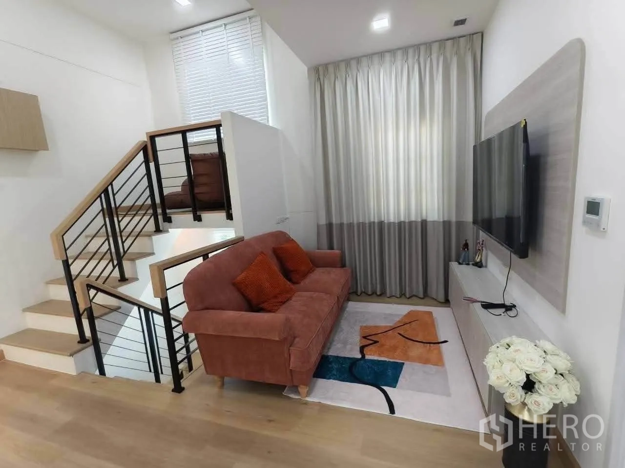 Detached House for rent in Bang Phli, Samut Prakan - Staircase beside a TV lounge with curtains and wooden steps.