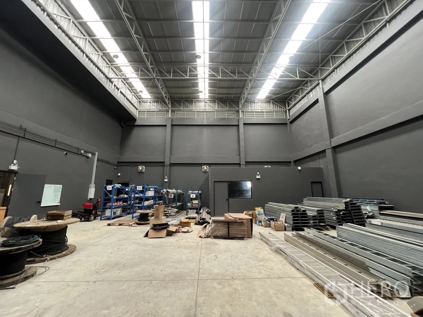 คลังสินค้า ขายในLat Krabang, Bangkok - ฮอลล์โกดังกว้าง มีชั้นวางเหล็กและไฟแถบสว่าง.