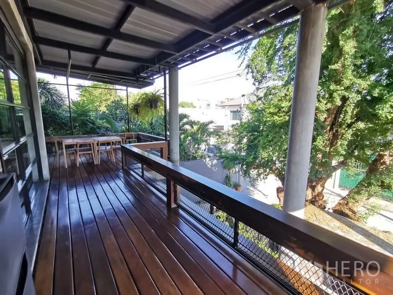 Home Office for sale in Wang Thonglang, Bangkok - Large covered balcony with seating area and leafy neighborhood views.