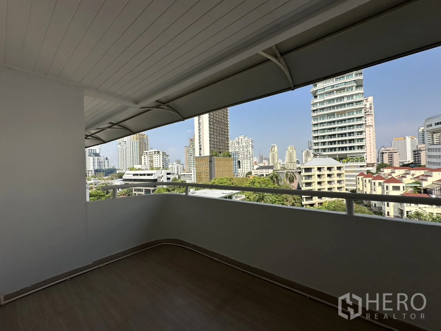 Condominium for rent in Watthana, Bangkok - Corner balcony with canopy and panoramic skyline views.
