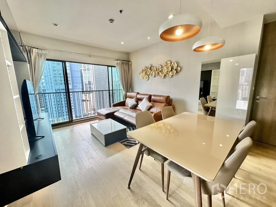 Condominium for rent in Bangkok - Bright living and dining area with leather sofa, pendant lights, TV console and balcony overlooking the Bangkok skyline.
