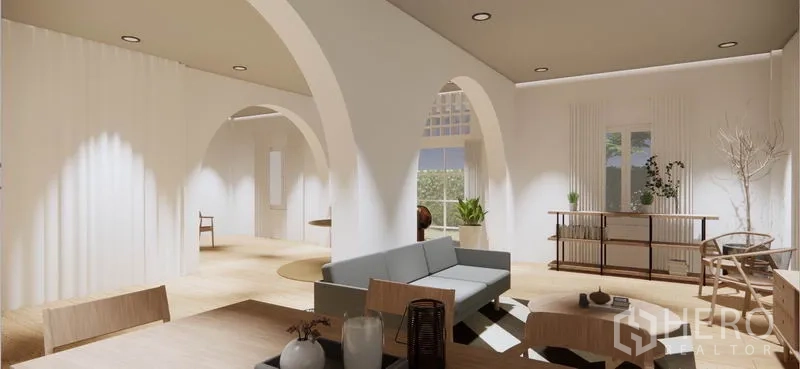 บ้าน ให้เช่าในKhlong Toei, Bangkok - มุมนั่งเล่นพร้อมโซฟา ช่องเว้าโค้ง หน้าต่างสูง และแสงธรรมชาติบนพื้นไม้