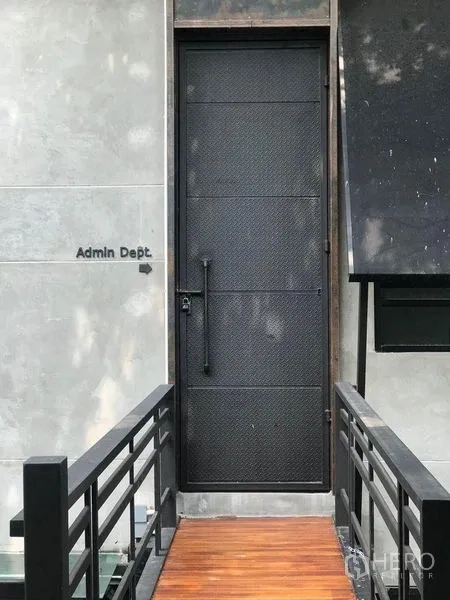 Office Space for rent in Bang Kapi, Bangkok - Close‑up of black steel door labeled Admin Dept with bridge walkway.