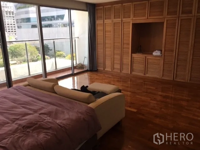 คอนโด ให้เช่าในPathum Wan, Bangkok - ห้องนอนใหญ่ ตู้บิลท์อินบานเกล็ดไม้ พื้นไม้ และประตูกระจกเชื่อมระเบียง