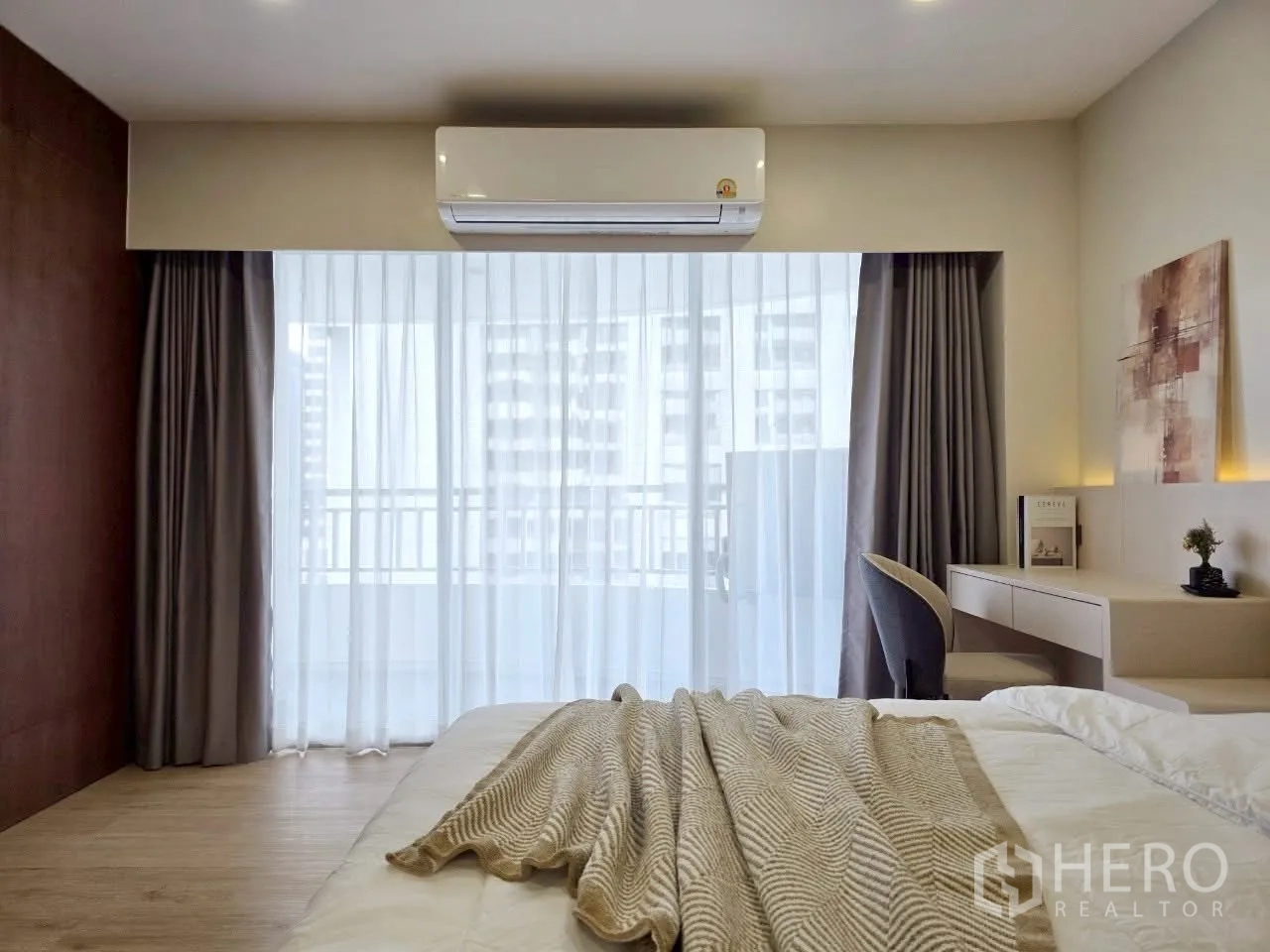 Condominium for rent in Sathon, Bangkok - Bedroom facing sheer curtains with balcony access and air conditioner.