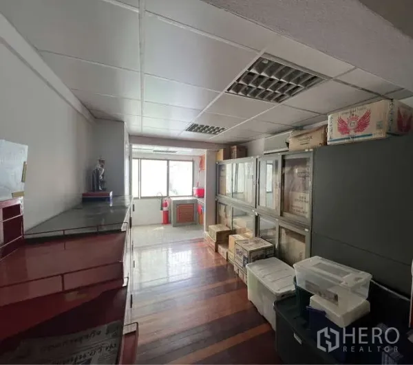 Office Space for rent - Upper-floor storage corridor with cabinets and wooden flooring.