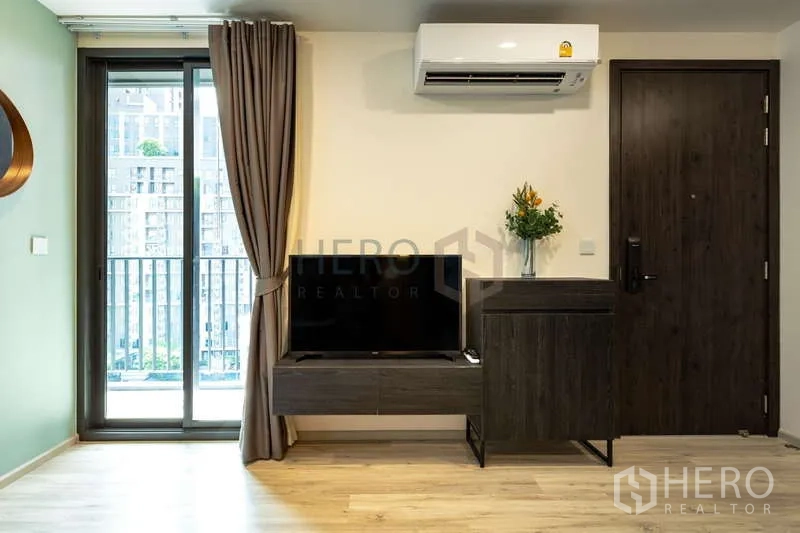 Condominium for rent or sale - Entry area with TV cabinet, air conditioner and door to the unit.