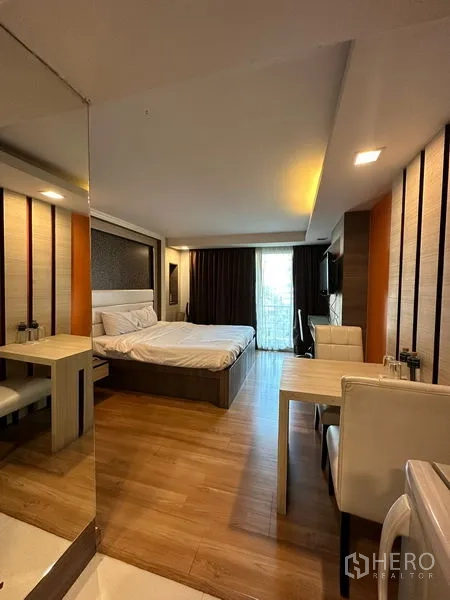 Apartment for rent in Khlong Toei, Bangkok - Modern low-rise apartment facade with multiple balconies and gated parking.