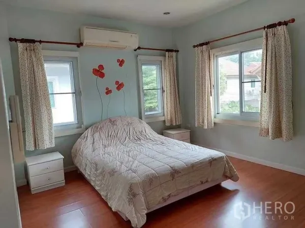 Detached House for sale in Bueng Kum, Bangkok - Air-conditioned bedroom with large windows, wood flooring and a double bed.