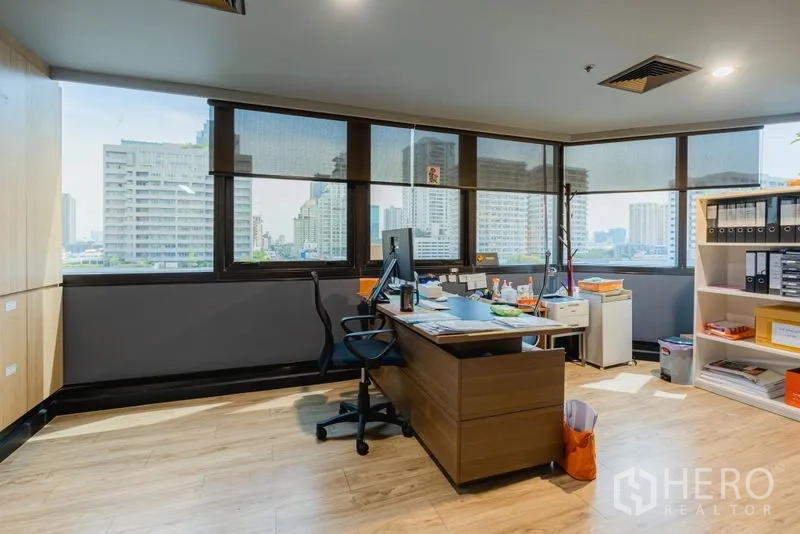 Office Space for rent - Private executive office with desk, storage and wide windows overlooking Bangkok.