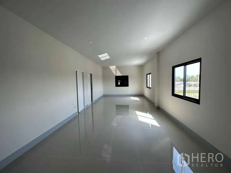 工厂 出租或出售在Sai Noi, Nonthaburi - 明亮的办公室内部，瓷砖地面与多扇窗户。