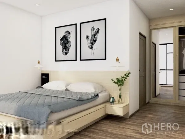 Condominium for rent or sale in Watthana, Bangkok - Minimalist master bedroom with queen bed, bedside shelves, framed artwork, and a built-in wardrobe.