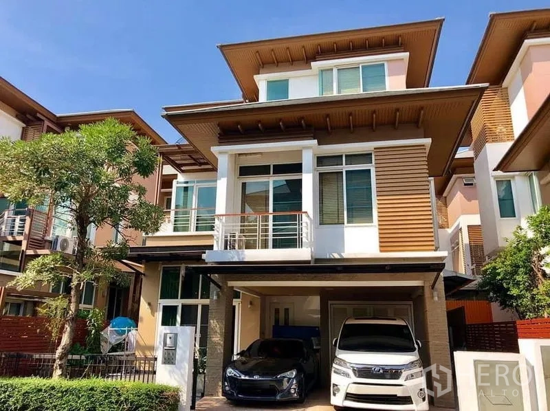 Detached House for sale in Bueng Kum, Bangkok - Modern three-storey detached house facade with balcony and covered parking for two cars.