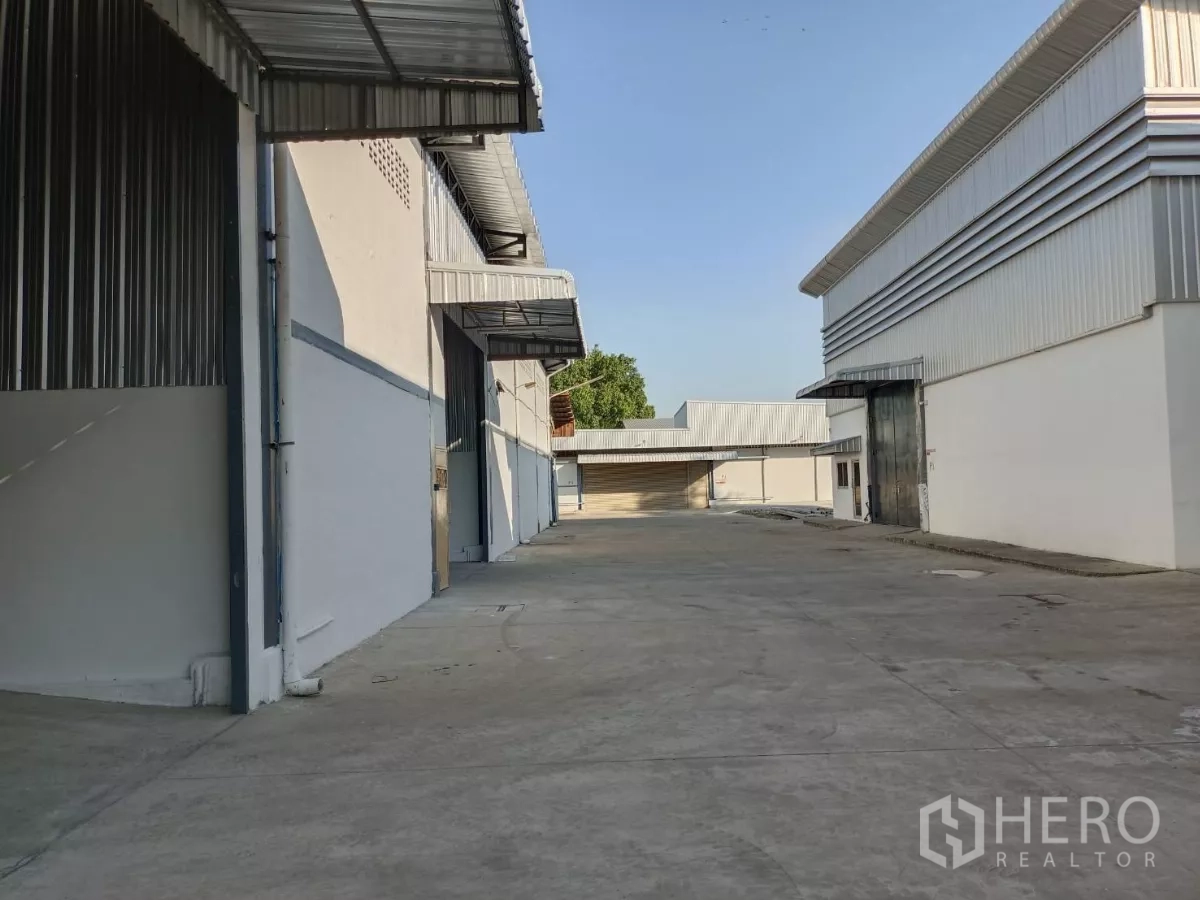 Warehouse for rent in Suan Luang, Bangkok - Wide access road between warehouse buildings providing ample truck maneuvering space.