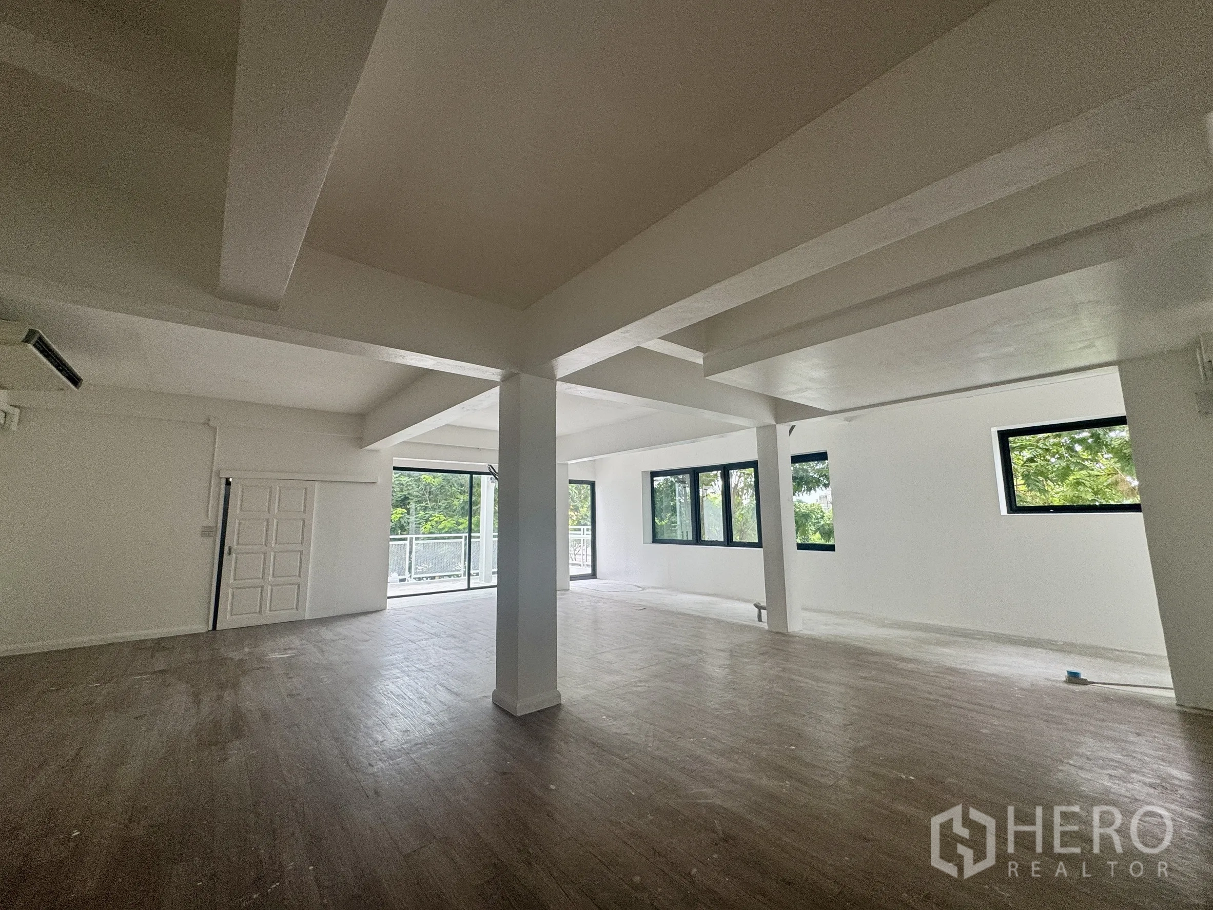 Office Space for rent in Sathon, Bangkok - Spacious white office floor with multiple windows and balcony access for natural light.