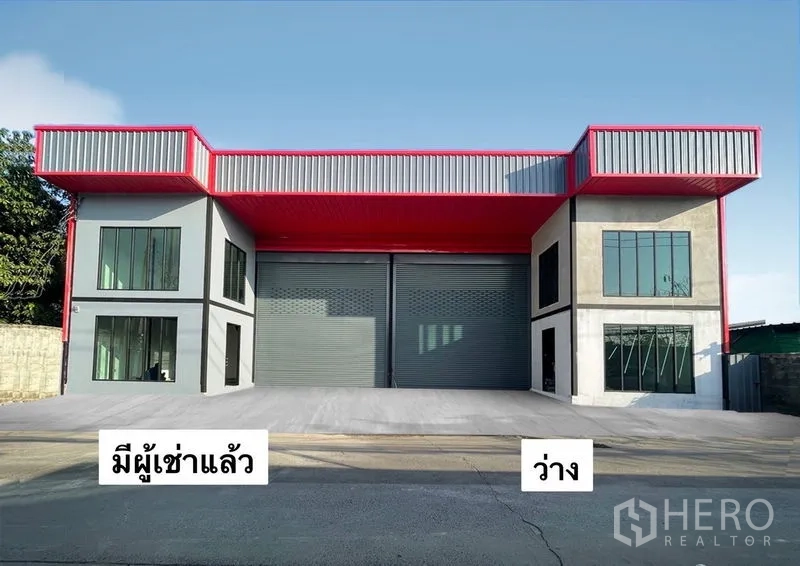 Warehouse for rent in Bang Kapi, Bangkok - Modern dual-bay warehouse exterior in Bang Kapi with red canopy, wide roller shutters and a spacious loading apron.