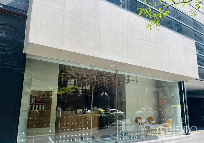 Retail Space for rent - Close-up of the retail unit’s floor-to-ceiling glass façade with a prominent signage panel.