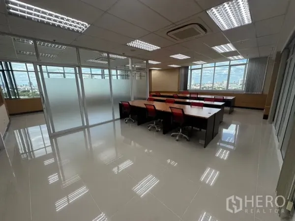 Office Space for rent in Suan Luang, Bangkok - Work area with multiple desks beside frosted glass rooms and panoramic windows.