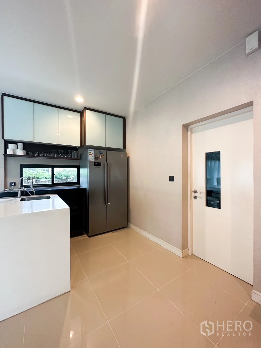 Detached House for rent or sale in Bang Kapi, Bangkok - Pantry or secondary kitchen with double-door fridge, sink and storage units.