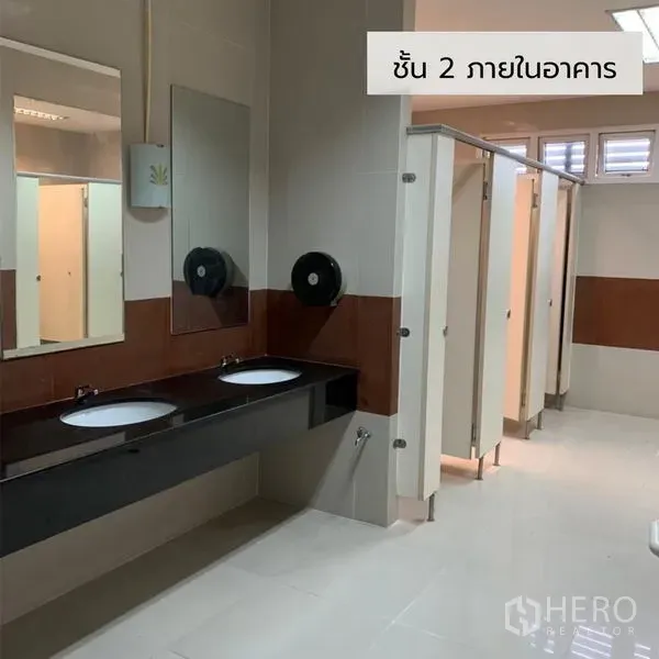 Office Space for rent in Bueng Kum, Bangkok - Modern restroom with double sinks and multiple toilet stalls in an office building.