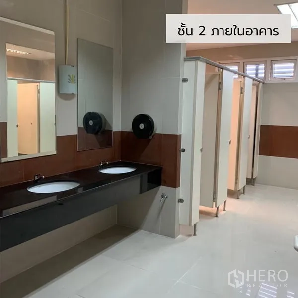 Office Space for rent in Bueng Kum, Bangkok - Modern restroom with double sinks and multiple toilet stalls in an office building.