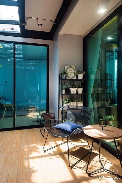 Townhouse for sale in Lak Si, Bangkok - Covered utility patio with glass roof, laundry area, and vertical garden.