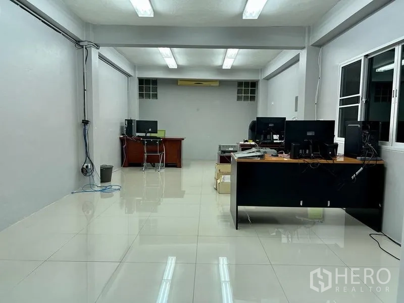 Shophouse for sale in Bang Kho Laem, Bangkok - Large open-plan office floor with desks, bright lighting and tiled floor.