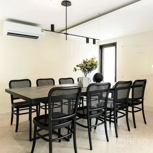 Office Space for rent in Watthana, Bangkok - Boardroom with a large dark table, black rattan chairs, and minimalist pendant lighting.