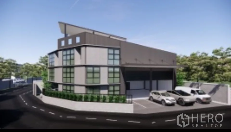 Home Office for rent in Mueang Nonthaburi, Nonthaburi - Modern three-storey home office with attached warehouse, covered loading bays and multiple parking spaces on a corner lot.